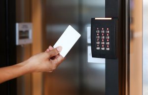 Door,Access,Control,-,Young,Woman,Holding,A,Key,Card